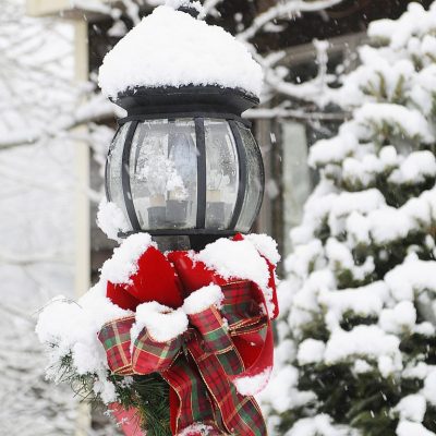 Christmas snow on streetlamp with bow